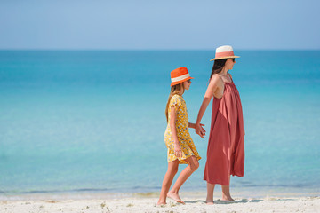 Wall Mural - Beautiful mother and daughter at Caribbean beach enjoying summer vacation.