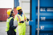 © linghaa - Young African american men and woman worker Check and control loading freight Containers by use computer laptop inspection at commercial shipping dock smiling felling happy. Cargo import export.