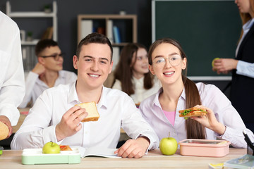 Pupils having lunch in classroom