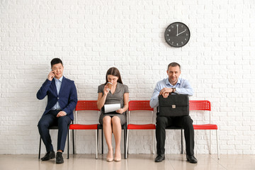 Business people waiting in line indoors