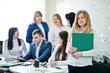 © AS Photo Family - Portrait of caucasian woman in white blouse hold green folder against business people group of bank workers.
