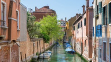A Waterway In The Middle Of Venice Between The Houses
