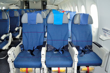 Empty passenger airplane seats in the cabin of plane.