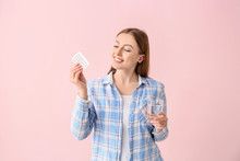 Young Woman With Birth Control Pills On Color Background
