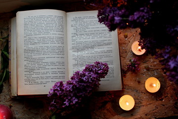 still life with flowers and candle. still life with candles. old book and candle. Flowers with candles