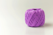 A Skein Of Thread Of Purple Color. Knitting Threads On A White Background. Hobby.