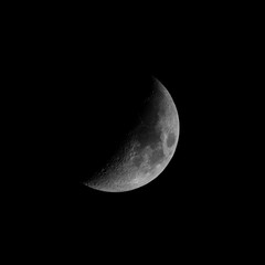 waxing crescent moon phase with black background