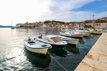 Wall Mural - Row boats moored at the waterfront of the town of Milna in the island of Brac in Croatia - Small fishing village in the Adriatic Sea