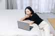 © Gengwit - Overworked and tired asian female sleeping over a laptop in a sofa at work in home. Work from home concpet.