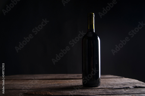 Cuadros en Lienzo Bottle On Table In Darkroom