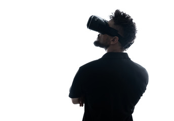 Man in dark T-shirt wearing virtual reality 3D headset and exploring the play