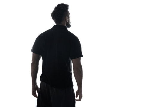 Fototapete - Silhouette of male person , back view back lit over white