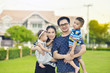 © jarun011 - Portrait of Asian family, mother, father and their kid in garden