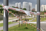 Fototapeta Sport - The park is closed by a ribbon with the inscription 