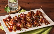 Close-up Of Bacon Wrapped Water Chestnuts Served On Plate At Table