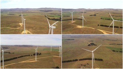 Wall Mural - a four way split screen of aerial view shots of large wind turbines rotating to create renewable ene