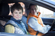 © Kekyalyaynen - Preteen boy with his Caucasian mother sitting inside a car, looking at camera