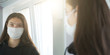 © Bonsales - closeup portrait of teenage girl wearing medical face mask looking in mirror quarantine concept