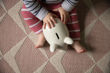 financial planning. baby with a piggy bank investing for their future