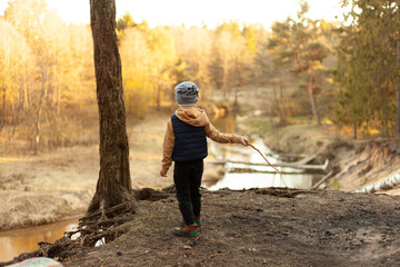 Wall Mural - little boy watching no river from a cliff in the forest camping, travel, tourism