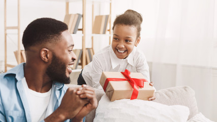 Wall Mural - Adorable black girl giving handmage girl to father