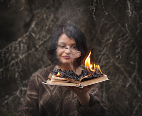 the book burns in the hands of a woman