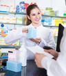 © JackF - female pharmacist helps a man buy a drug