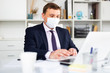 © JackF - Man in protective face mask working at office