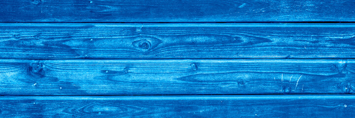 wooden boards background. aged burned black and blue wooden planks. toned classic blue color trend 2