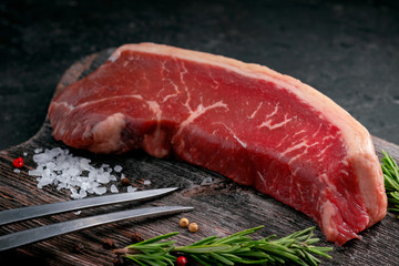 Poster - Raw Brazilian steak beef picanha on a wooden Board with salt and rosemary