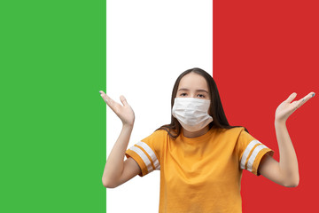 Wall Mural - When will the coronavirus epidemic in Italy end. Girl in antibacterial medical mask makes a helpless gesture, asks a question against the background of the flag with copyspace