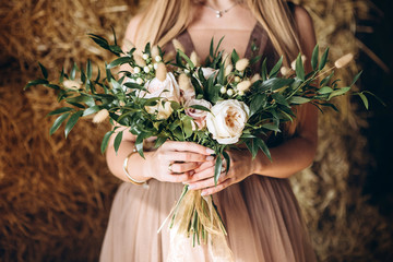 Wall Mural - bride in a white dress with a chic bouquet in her hands. Luxury wedding bouquet. The girl is holding flowers - roses, peonies, archedes.