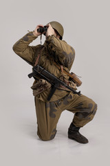 Wall Mural - Actor man in an old military uniform and camouflage clothing of a soldier of the Soviet army during the World War II