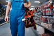 © Nomad_Soul - Male worker in uniform holds toolbox in tool store