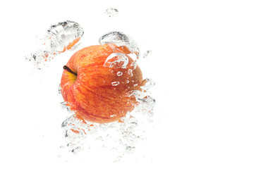 Wall Mural - Apple falls under water with a splash. With lots of air bubbles