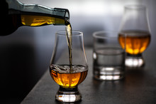 Pouring In Tulip-shaped Tasting Glass Scotch Single Malt Or Blended Whisky