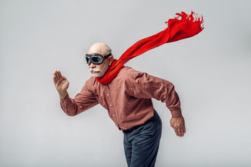 Elderly man in a red scarf and pilot glasses