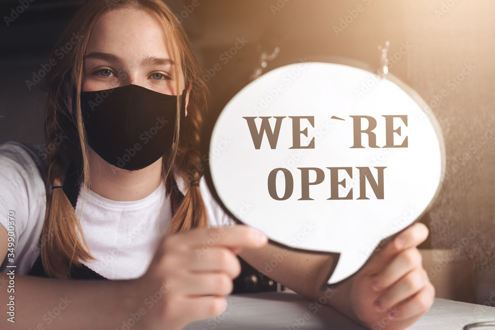 Coronavirus covid 19.Coffee shop woman owner with face mask, open after lockdown quarantine.End quarantine. Announcement we are open nv doors,  resumption shops, cafes,coffee houses, small businesses - obrazy, fototapety, plakaty 