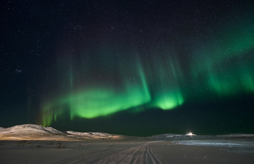 landscape with northern lights on the coast of the barents sea on the kola peninsula at night at hig