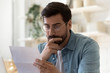© fizkes - Frustrated millennial guy in glasses read bad unpleasant news in postal letter, sad confused young man consider paperwork get negative answer in post correspondence, eviction or dismissal notice