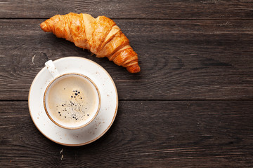 Canvas Print - Coffee and croissants on wooden table