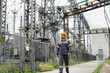 © Andrii - An engineering employee makes a tour and inspection of a modern electrical substation. Energy. Industry