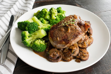 Wall Mural - Filet Mignon in Mushroom Wine Sauce: Filet mignon steak with a creamy mushroom sauce served with broccoli florets