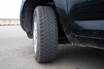 Car winter tire detail closeup, used car tires texture