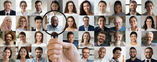 Fotografía Male employer holding magnifier in hand finding unique talent african ethnic job candidate choosing among many lot of multiethnic people different faces collage