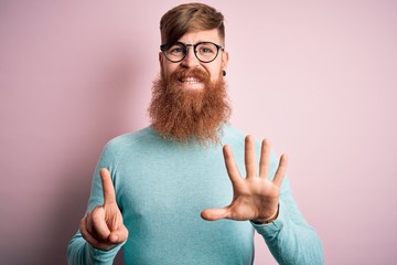 Canvas Print - Handsome Irish redhead man with beard wearing glasses over pink isolated background showing and pointing up with fingers number six while smiling confident and happy.