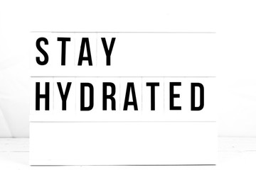 Stay Hydrated quote on vintage retro board. Concept. flat lay