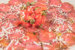 Dish of Iberian beef tenderloin carpaccio with tomato, and olive oil