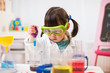 toddler girl pretend play scientist role  at home against white background