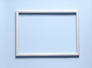 Photo silver frame with space for text on blue background.